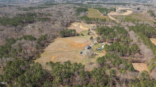 birds eye view of property featuring a wooded view