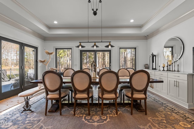 dining space featuring a raised ceiling, crown molding, and recessed lighting