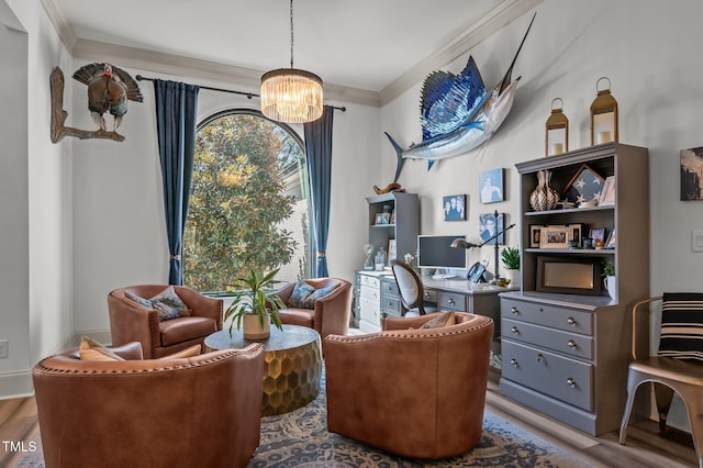 sitting room featuring ornamental molding, wood finished floors, and a notable chandelier