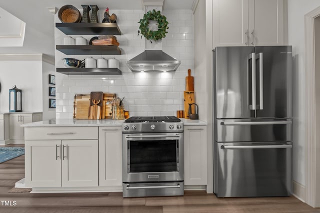 kitchen with stainless steel appliances, tasteful backsplash, open shelves, and wood finished floors