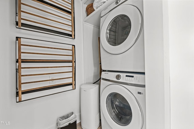 washroom with stacked washer / dryer and laundry area