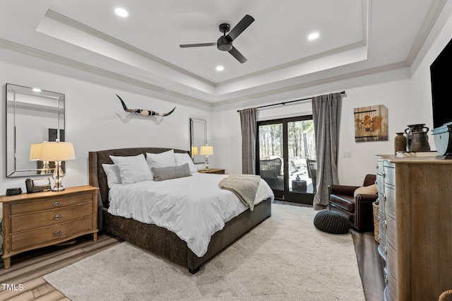 bedroom featuring access to exterior, ornamental molding, and a raised ceiling