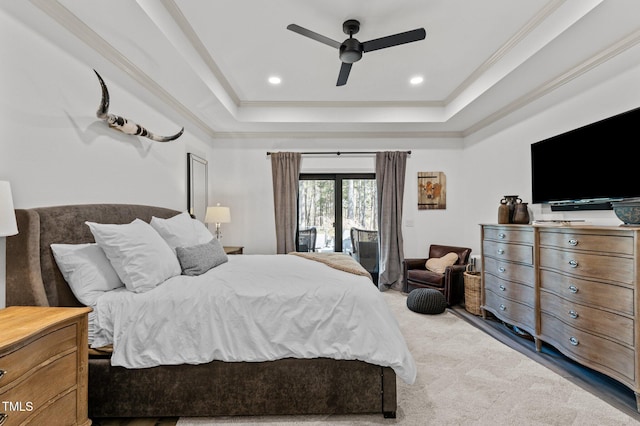 carpeted bedroom featuring access to exterior, recessed lighting, a raised ceiling, ornamental molding, and a ceiling fan