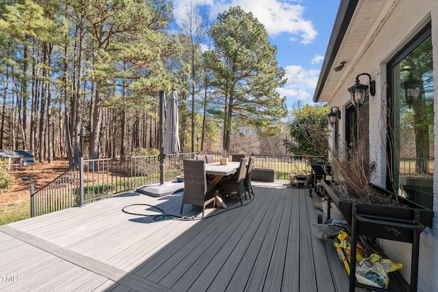 wooden terrace with outdoor dining area