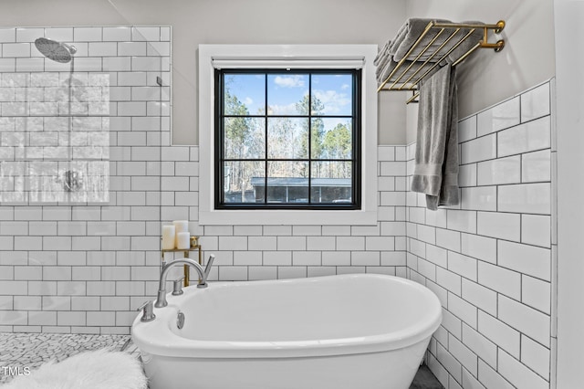 full bathroom with a freestanding tub, a tile shower, and tile walls