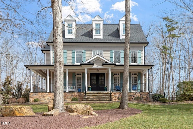 view of front facade featuring covered porch, roof with shingles, french doors, and a front lawn