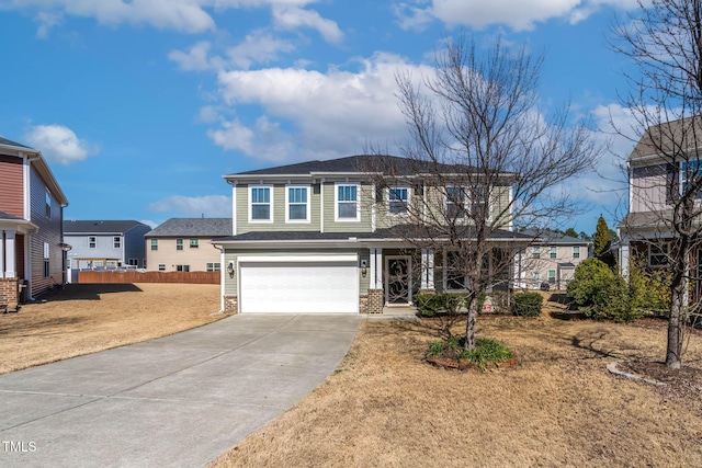 traditional-style home featuring a garage, brick siding, fence, driveway, and a front yard