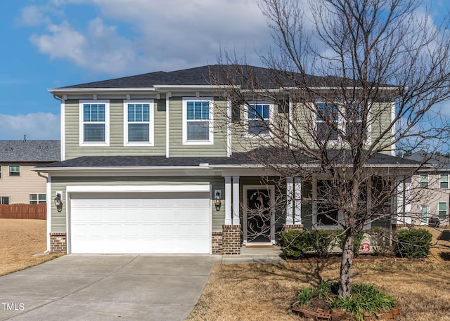 view of front of home with a garage, driveway, brick siding, and fence