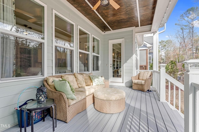 wooden deck featuring outdoor lounge area and a ceiling fan