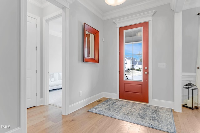 foyer entrance featuring light wood-style flooring, baseboards, and crown molding