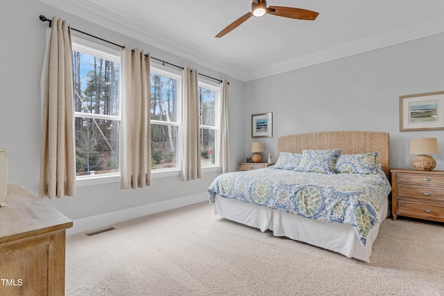 bedroom featuring baseboards, visible vents, ceiling fan, carpet, and crown molding