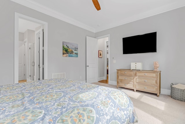 bedroom featuring ceiling fan, carpet floors, visible vents, baseboards, and ornamental molding