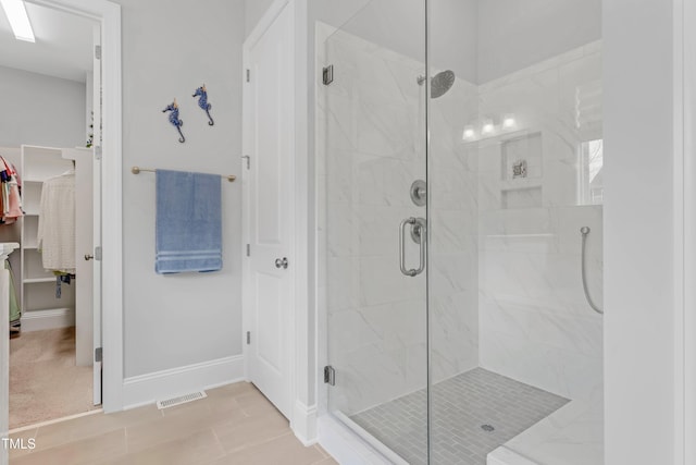 full bathroom featuring a stall shower, visible vents, and baseboards