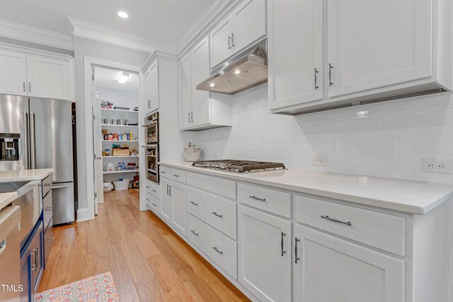 kitchen featuring stainless steel appliances, light wood-type flooring, white cabinetry, and under cabinet range hood