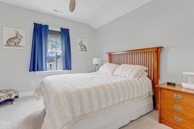 bedroom featuring ceiling fan, carpet flooring, visible vents, baseboards, and vaulted ceiling