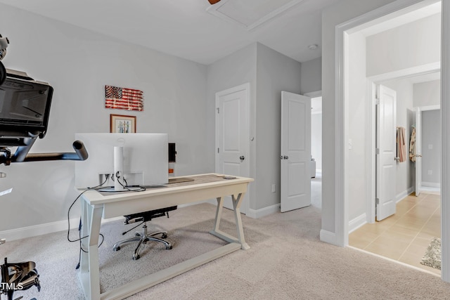 office space with baseboards and light colored carpet