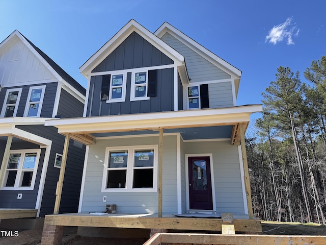 view of front facade with covered porch and board and batten siding