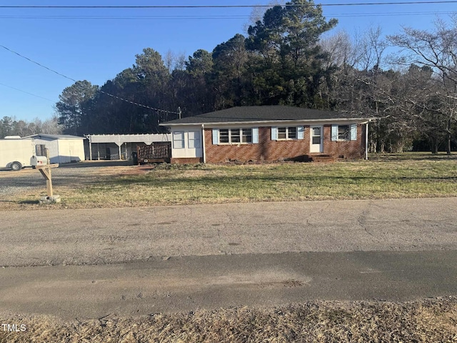 single story home with a front yard, brick siding, and crawl space