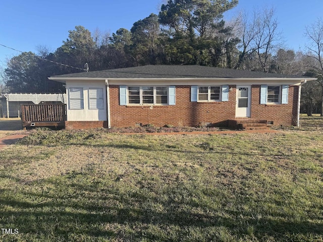 view of front of house with entry steps, a front lawn, brick siding, and crawl space