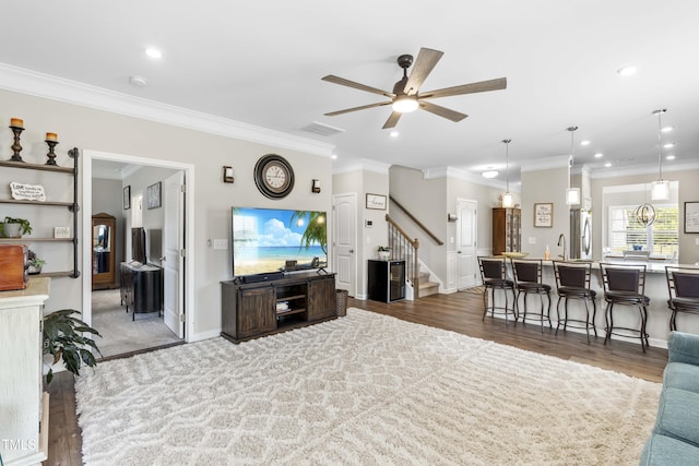 living room with visible vents, a ceiling fan, stairway, crown molding, and recessed lighting