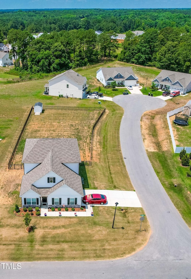 birds eye view of property featuring a view of trees