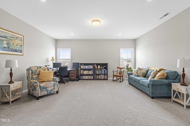 carpeted living room with baseboards, visible vents, and recessed lighting