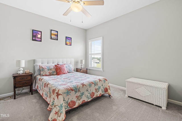 carpeted bedroom featuring baseboards and a ceiling fan