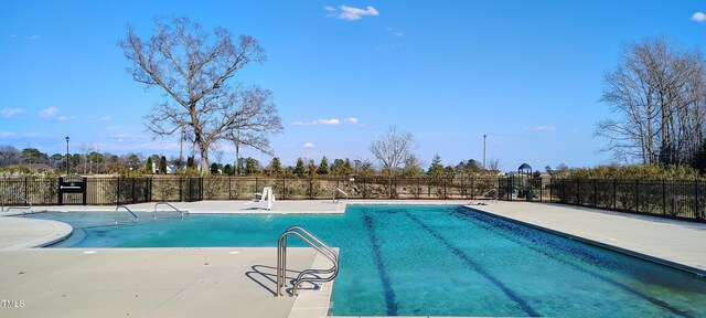 view of pool featuring fence, a fenced in pool, and a patio