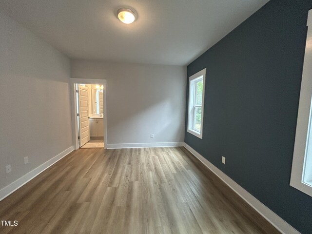 504 Yeowell Dr, Chapel Hill, NC 27514 - unfurnished bedroom featuring wood finished floors and ensuite bath