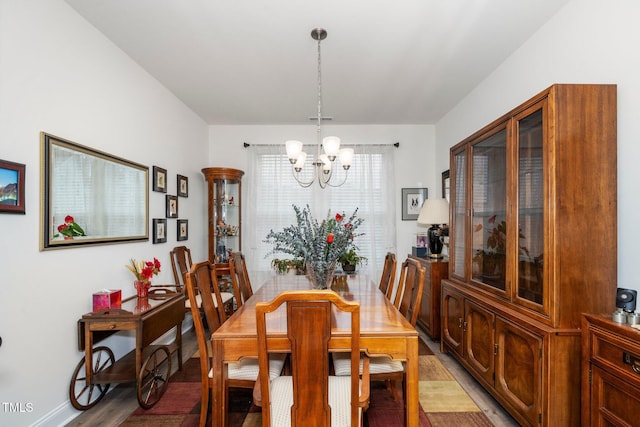 dining room featuring a notable chandelier and wood finished floors