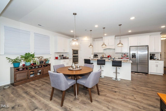 dining area featuring dark wood-style floors, recessed lighting, and visible vents