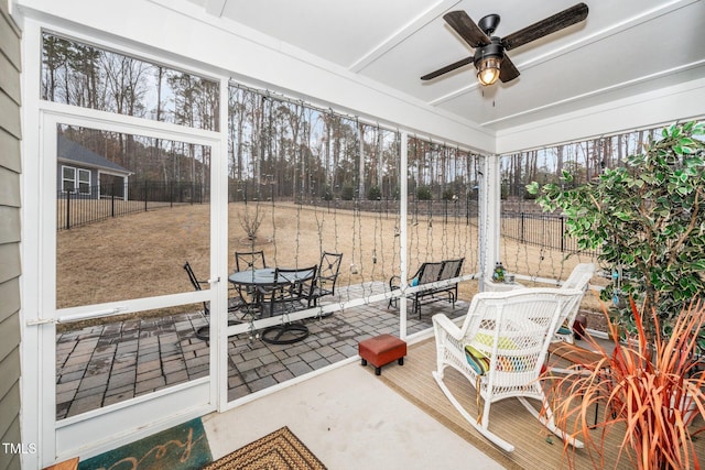 sunroom / solarium with ceiling fan