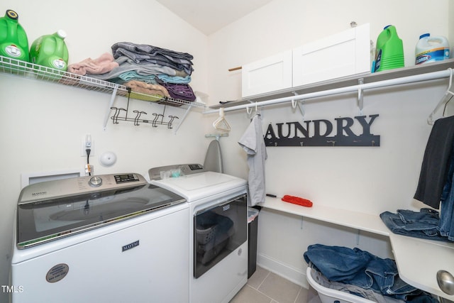 laundry room featuring laundry area, washing machine and clothes dryer, and light tile patterned floors