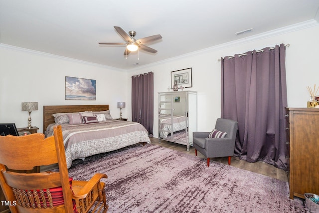 bedroom with ornamental molding, wood finished floors, and visible vents