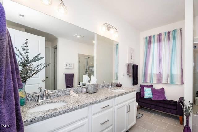 bathroom featuring visible vents, a sink, a shower stall, and double vanity