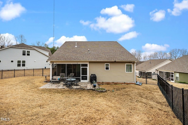 back of property featuring a patio area, a fenced backyard, a shingled roof, and a lawn