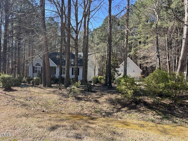 view of front facade featuring a forest view