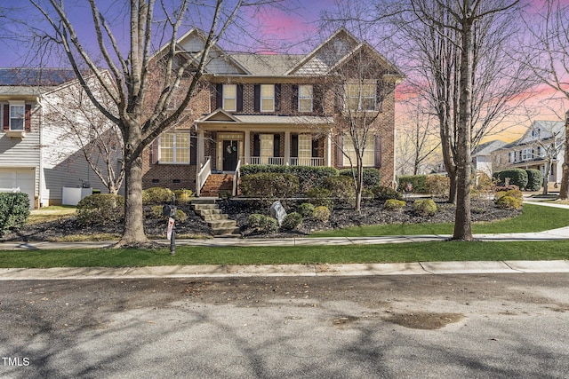 view of front of house with covered porch, brick siding, and crawl space