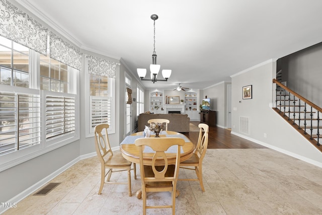 dining space with baseboards, visible vents, stairway, crown molding, and a fireplace