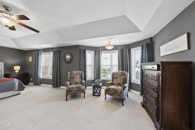 bedroom with light carpet, visible vents, baseboards, and a tray ceiling