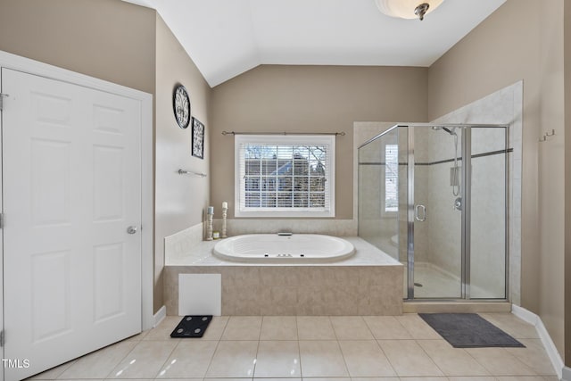 full bath with lofted ceiling, a stall shower, tile patterned flooring, and a bath