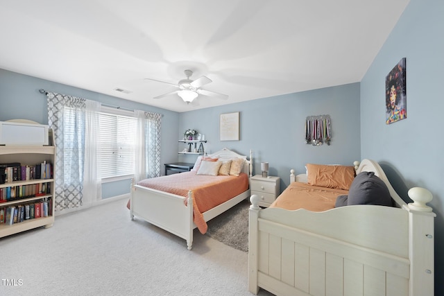 bedroom featuring light carpet, ceiling fan, and visible vents