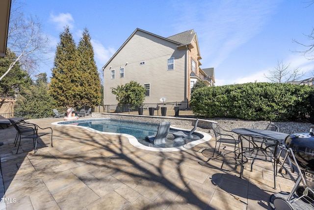 view of swimming pool featuring a patio area, fence, and a fenced in pool