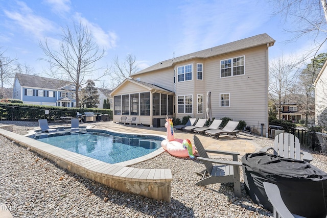 view of pool featuring a patio area, fence, a sunroom, and a fenced in pool