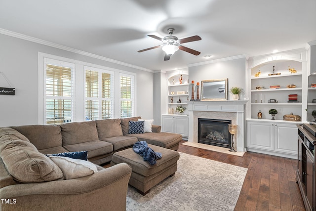 109 Skywater Ln, Holly Springs, NC 27540 - living room featuring ornamental molding, ceiling fan, dark wood-style floors, a high end fireplace, and built in shelves