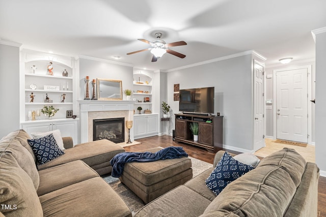 109 Skywater Ln, Holly Springs, NC 27540 - living area with a ceiling fan, wood finished floors, a fireplace, ornamental molding, and built in shelves
