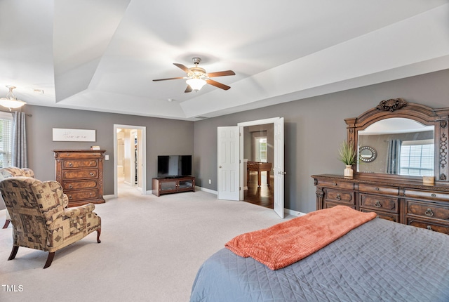 109 Skywater Ln, Holly Springs, NC 27540 - bedroom featuring a tray ceiling, carpet, connected bathroom, and a ceiling fan