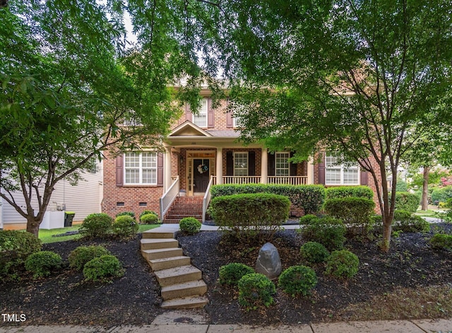 109 Skywater Ln, Holly Springs, NC 27540 - obstructed view of property with brick siding, covered porch, and stairway