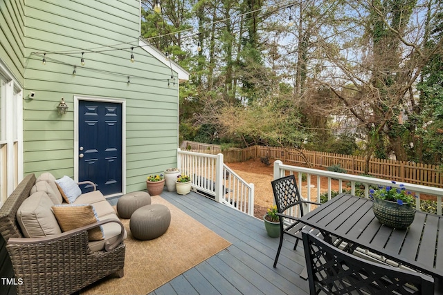 wooden deck featuring a fenced backyard and outdoor dining area