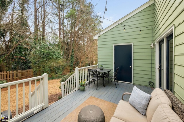 wooden deck with fence and outdoor dining area